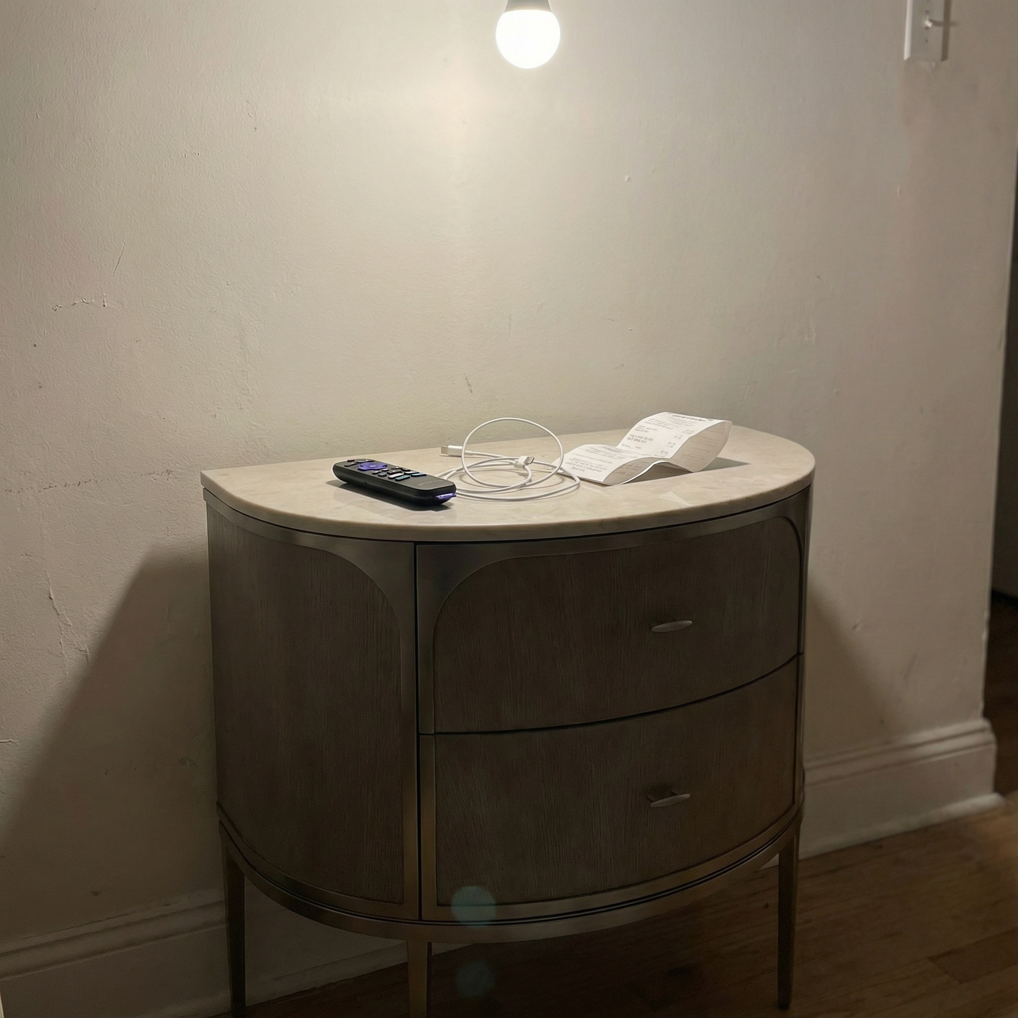 Conduit nightstand - messy room photo with remote and receipt